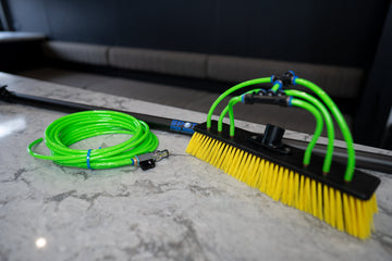 Water fed pole brush head for solar panel and window cleaning