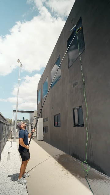 Cleaning second storey windows from the ground with a Spot Free Rinse water fed pole