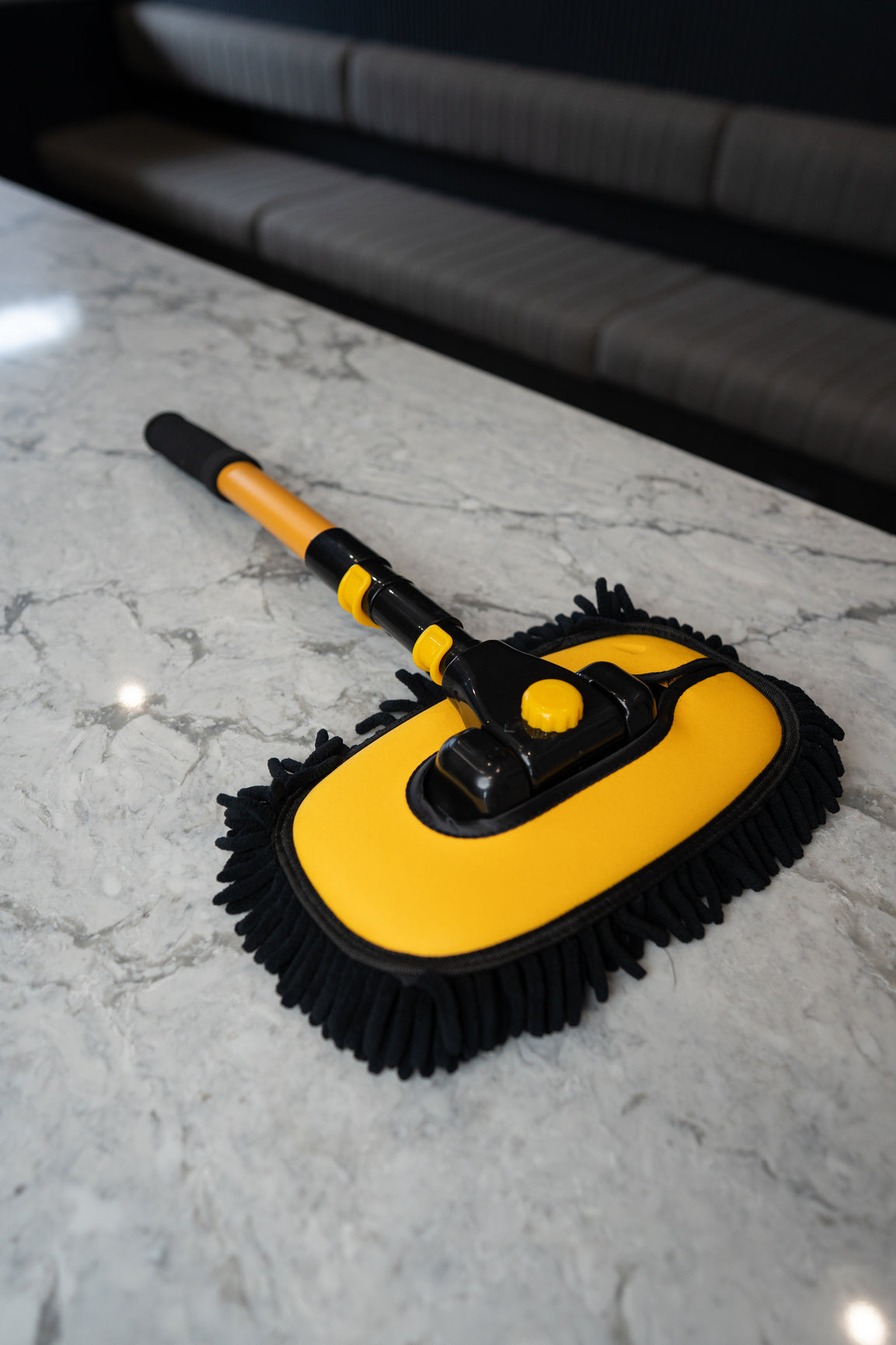 Spot Free Rinse telescopic car wash mop in black and yellow on a benchtop