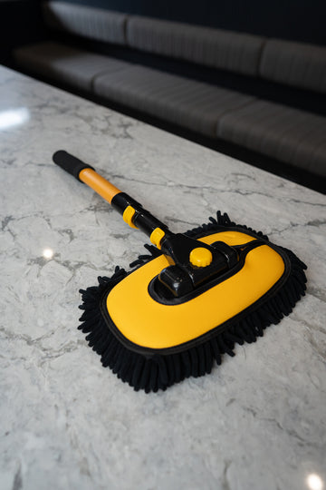 Spot Free Rinse telescopic car wash mop in black and yellow on a benchtop