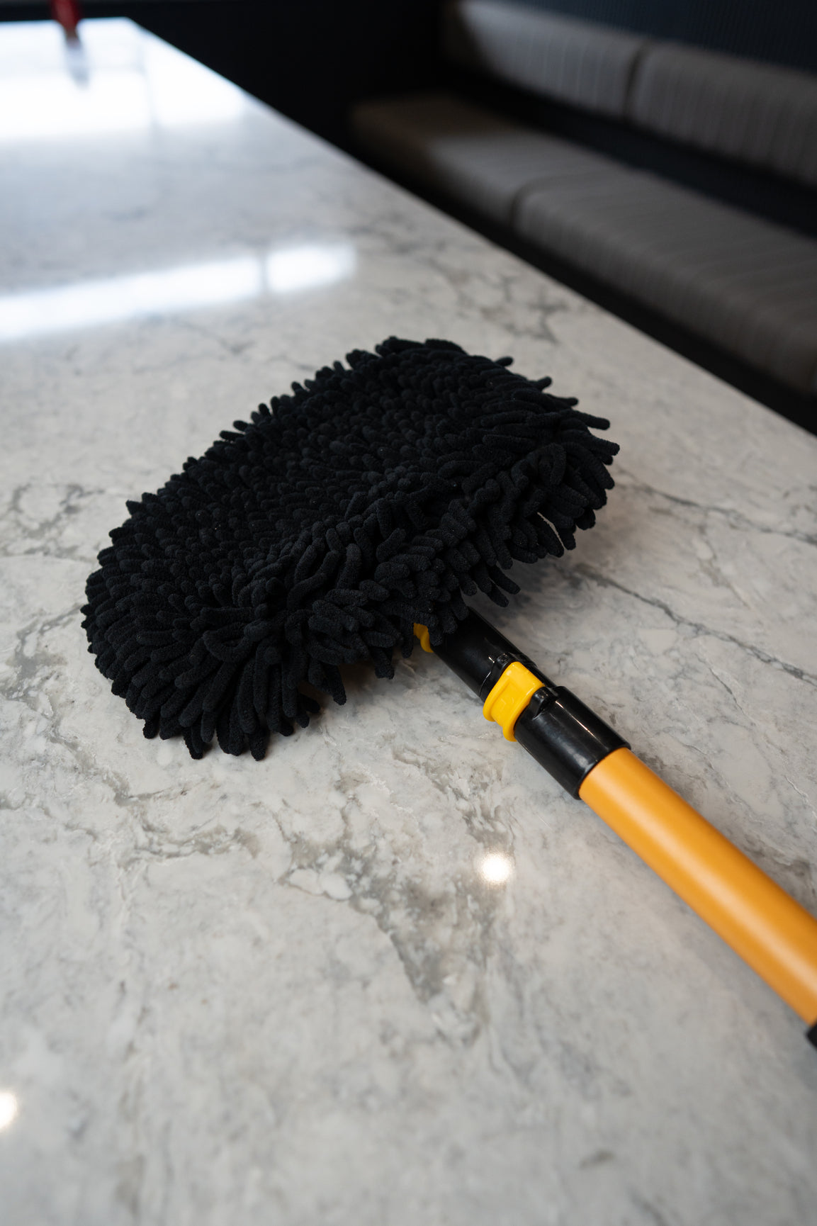 Underside of the car wash mop showing the thick black chenille wash surface