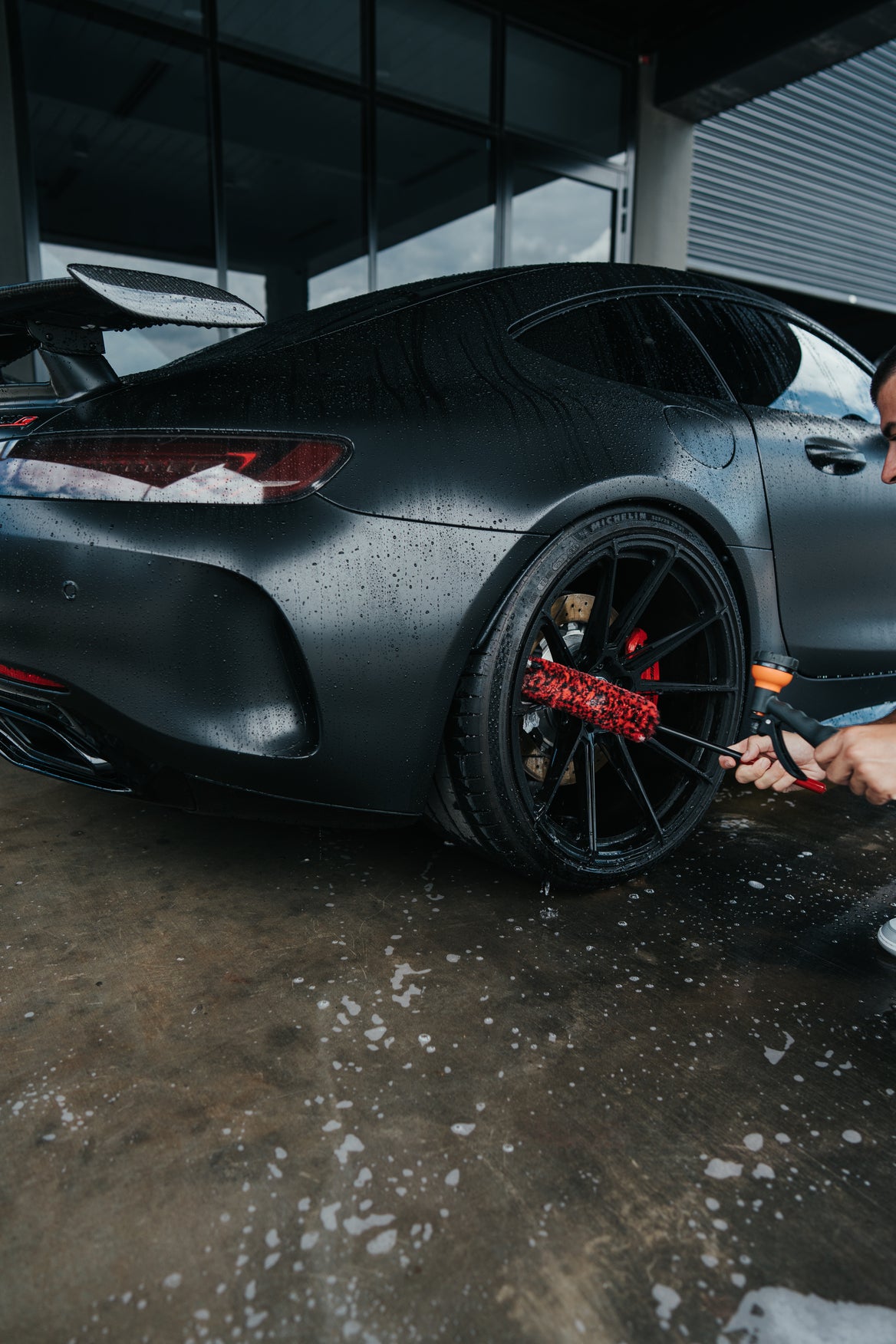 Synthetic wool wheel brush being used on alloy wheel for scratch-free cleaning