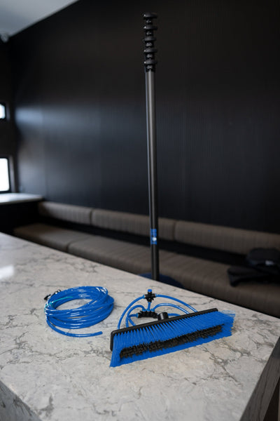 22ft hybrid water fed pole standing at full length with brush and hose