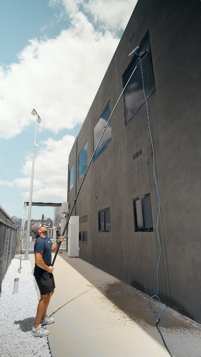 Water fed pole reaching the upper windows of a commercial building