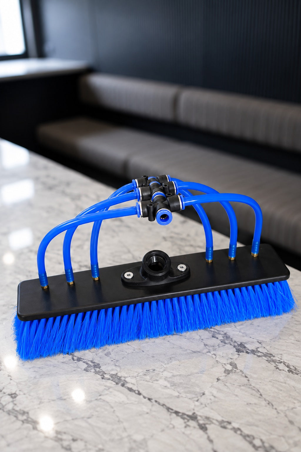 Top of the blue nylon water fed pole brush showing the threaded socket and jet tubes