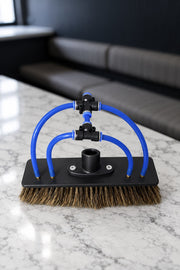 Top of the boar's hair water fed pole brush showing the threaded socket, blue tubes and fittings