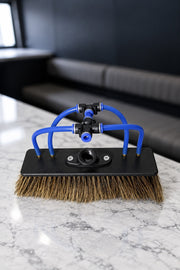 Boar's hair water fed pole brush with 4 jets and blue push fit tubes on a marble benchtop