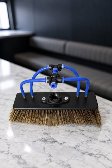 Boar's hair water fed pole brush with 4 jets and blue push fit tubes on a marble benchtop