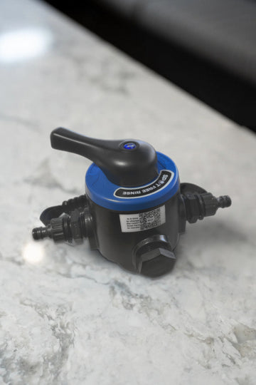 Spot Free Rinse tank head with bypass on a marble bench, showing the bypass lever, inlet and outlet fittings and the resin reorder QR label