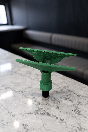 Green Fixi clamp for a water fed pole with its jaws open, standing on its black threaded adapter